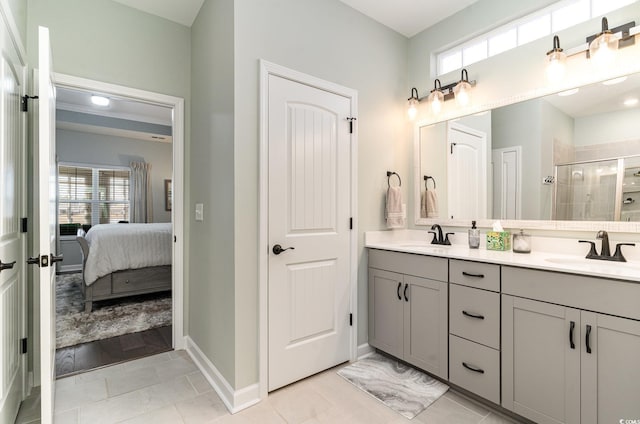 ensuite bathroom featuring a wealth of natural light, a sink, and a stall shower