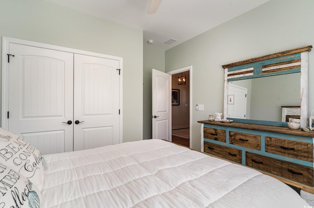 bedroom featuring a closet, a fireplace, visible vents, and a ceiling fan