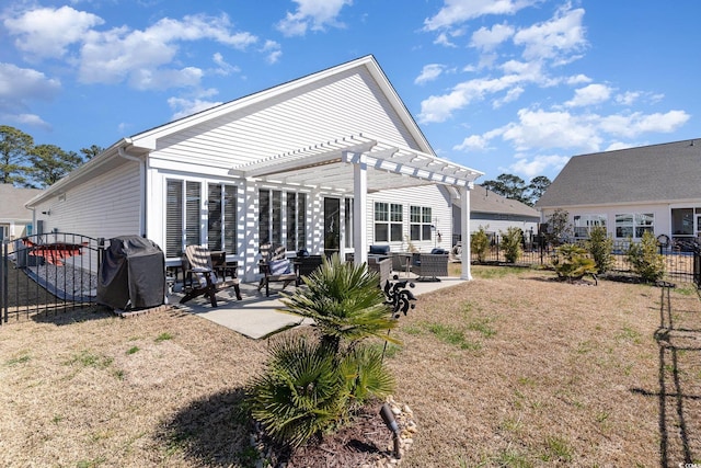 back of property with a patio area, fence, and a pergola