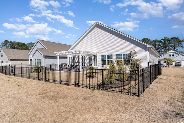 rear view of property with fence and a pergola