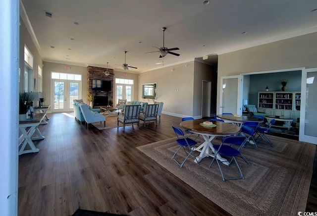 dining space with crown molding, visible vents, dark wood-type flooring, and french doors