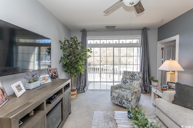 living room featuring light carpet and ceiling fan