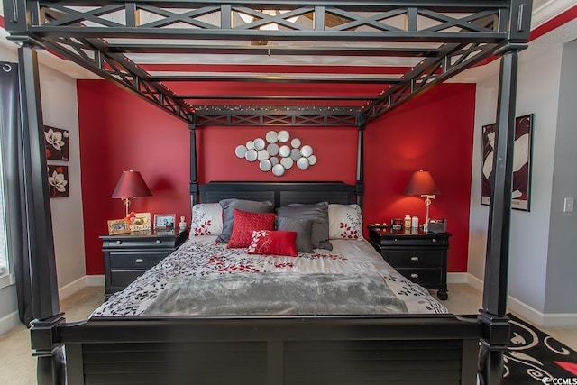 bedroom featuring carpet and baseboards