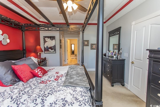 bedroom with light colored carpet, connected bathroom, ceiling fan, a garage, and baseboards