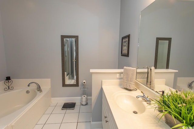 bathroom featuring vanity, baseboards, a bath, and tile patterned floors