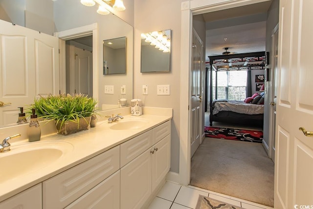 bathroom featuring double vanity, tile patterned floors, a sink, and connected bathroom