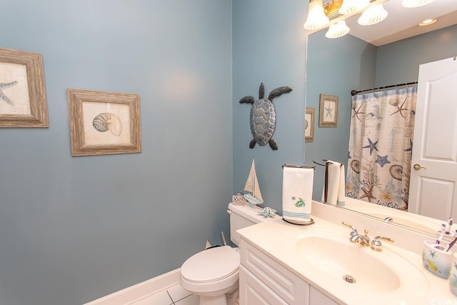 bathroom with curtained shower, toilet, vanity, baseboards, and tile patterned floors