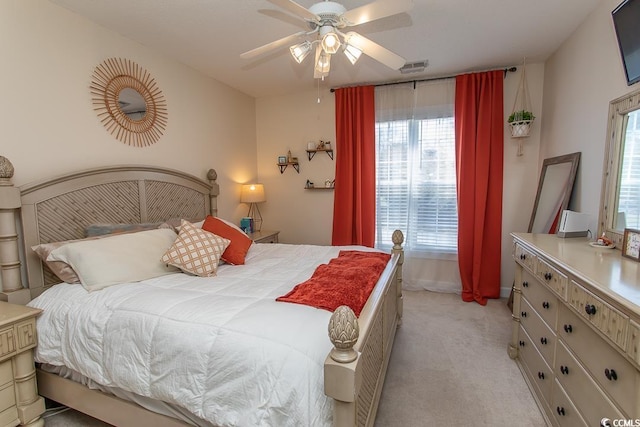 bedroom featuring a ceiling fan, light colored carpet, and visible vents