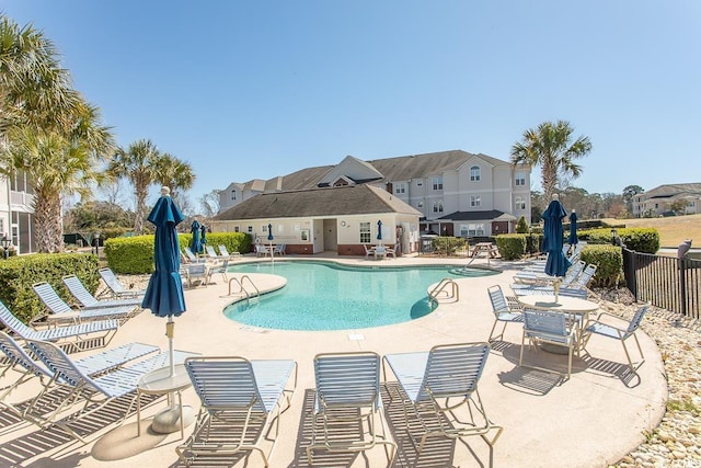 community pool featuring a patio area and fence