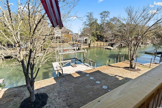 view of dock featuring a water view, boat lift, and fence