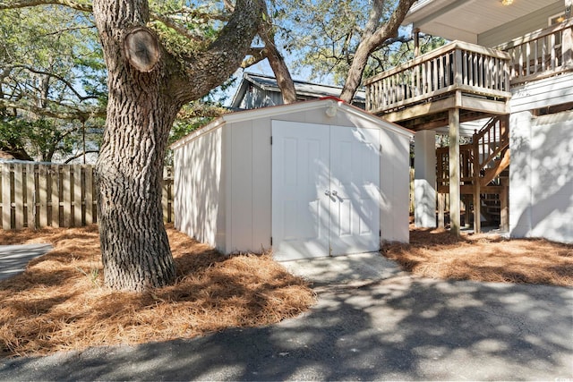 view of shed featuring fence