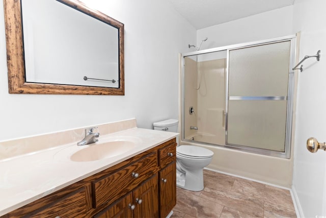 full bathroom with toilet, enclosed tub / shower combo, and vanity