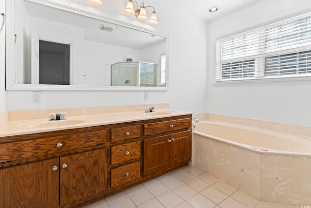 full bath with a garden tub, tile patterned flooring, a sink, and a shower stall