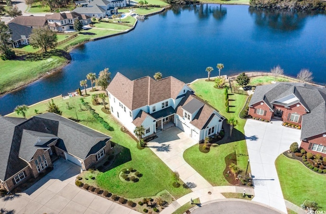 birds eye view of property featuring a water view and a residential view