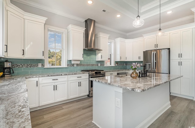 kitchen with pendant lighting, visible vents, appliances with stainless steel finishes, light stone countertops, and wall chimney exhaust hood