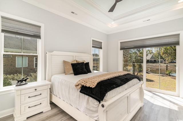 bedroom with access to outside, visible vents, crown molding, and wood finished floors