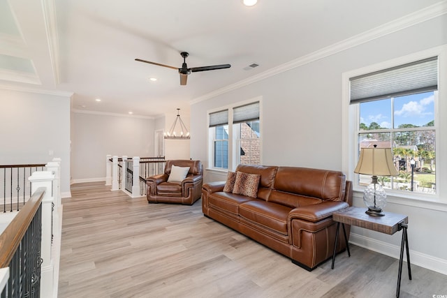 living area with light wood-type flooring, visible vents, and baseboards