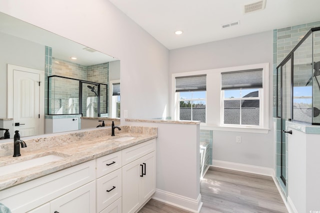 bathroom featuring a sink, visible vents, and a shower stall