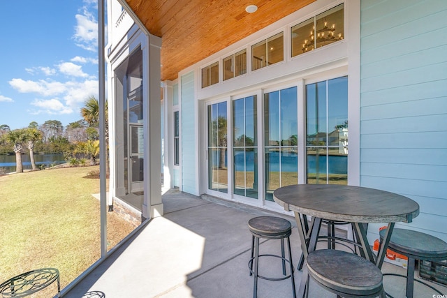 balcony featuring a patio area and a water view