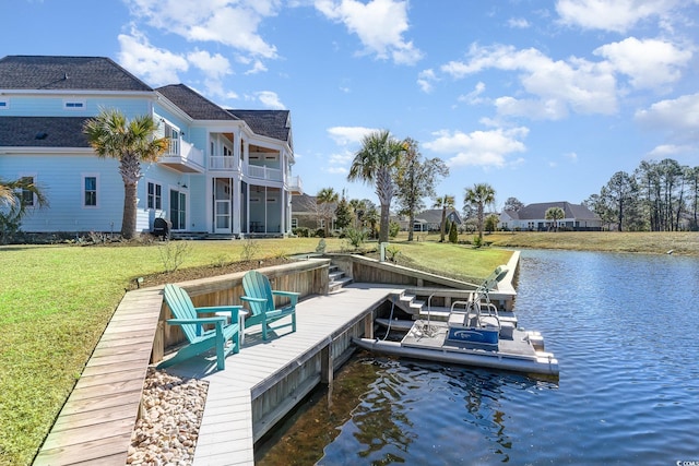 dock area featuring a lawn, a water view, and a balcony