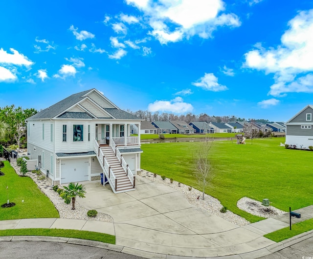 view of front facade with a garage, a residential view, driveway, and a front lawn