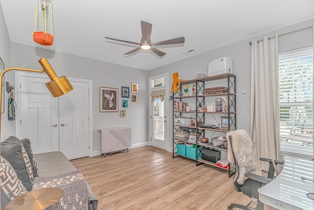 office space with ceiling fan, light wood-style floors, and baseboards