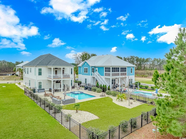 rear view of property with a balcony, stairway, an outdoor hangout area, a patio, and an in-ground hot tub