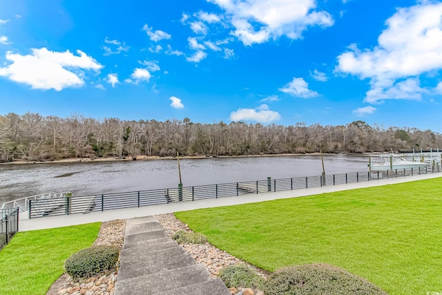 view of yard with a water view and a forest view