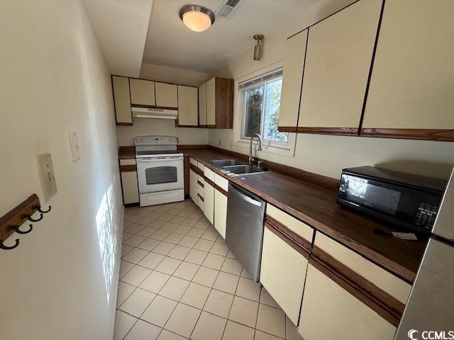 kitchen with white electric stove, visible vents, stainless steel dishwasher, a sink, and under cabinet range hood