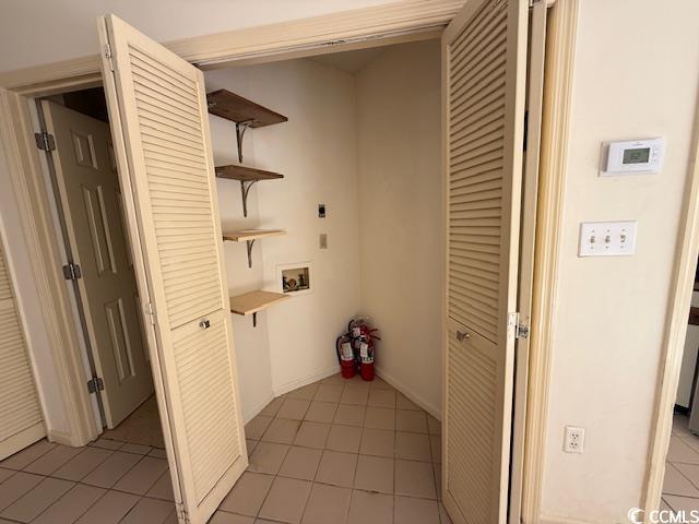 washroom with laundry area, hookup for a washing machine, hookup for an electric dryer, and light tile patterned flooring