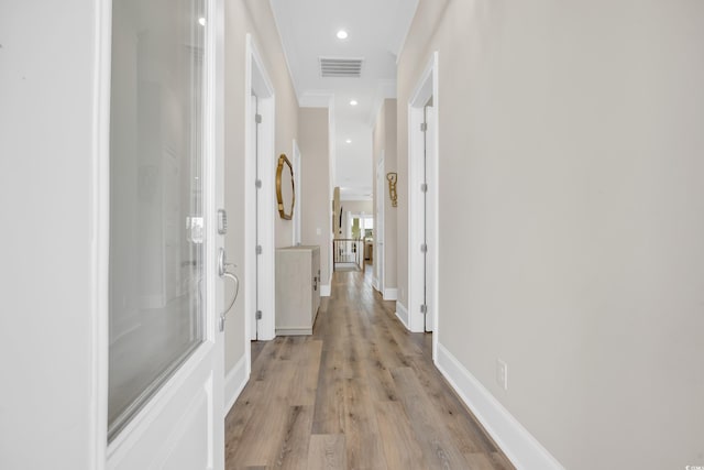 hallway featuring recessed lighting, baseboards, visible vents, and light wood finished floors