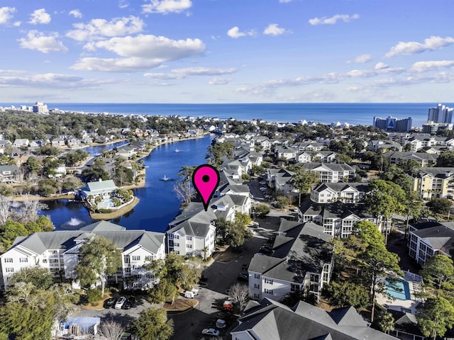 drone / aerial view with a water view and a residential view