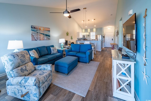 living area with high vaulted ceiling, dark wood-style flooring, and a ceiling fan