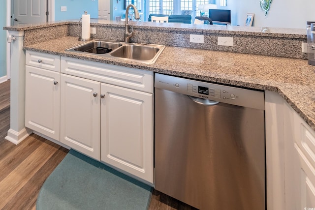 kitchen featuring dark wood-style floors, stainless steel dishwasher, a sink, and white cabinets