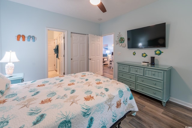 bedroom featuring dark wood-type flooring, a closet, ceiling fan, and baseboards