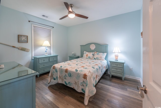 bedroom featuring a ceiling fan, baseboards, visible vents, and dark wood-type flooring