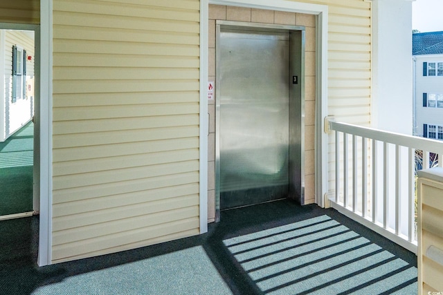 entrance to property with a balcony and elevator