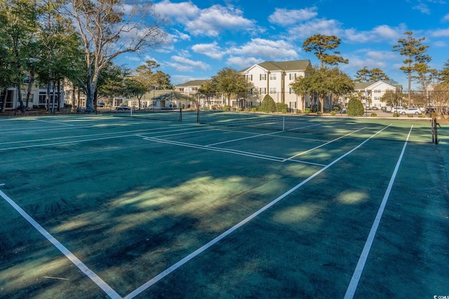 view of sport court featuring fence