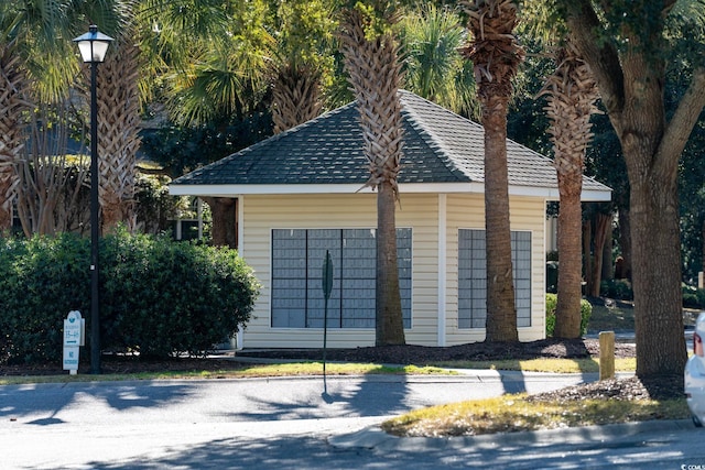 exterior space with a shingled roof