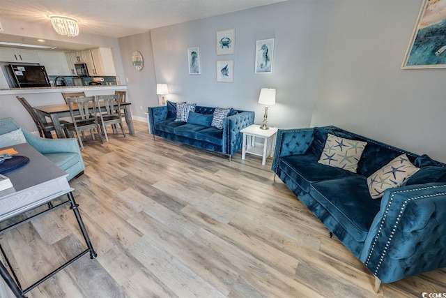 living area with light wood-style floors and baseboards