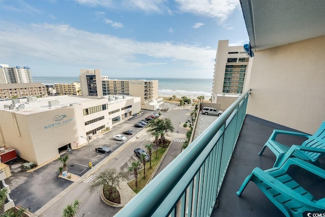 balcony featuring a water view and a view of the beach