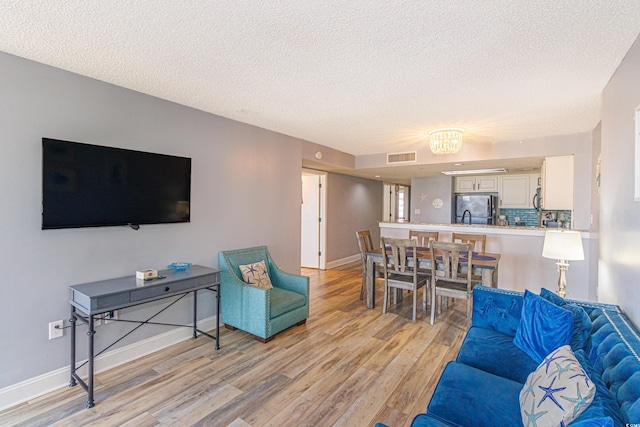 205 74th Ave N Unit 702, Myrtle Beach, SC 29572 - living area with light wood-type flooring and a textured ceiling