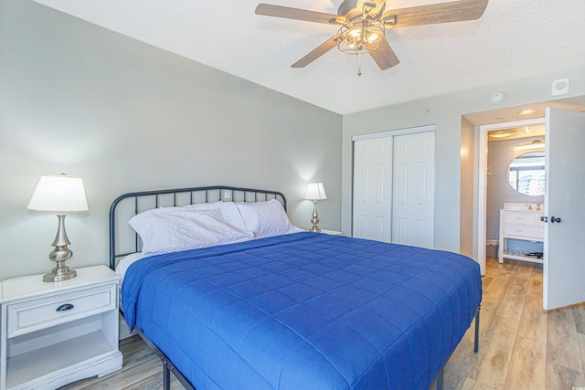 205 74th Ave N Unit 702, Myrtle Beach, SC 29572 - bedroom with a closet, a textured ceiling, light wood-style floors, and a ceiling fan