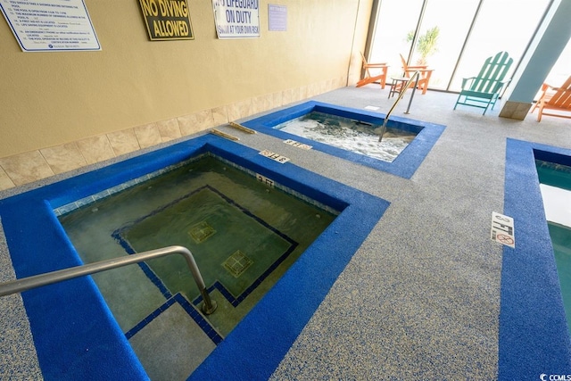 view of pool with an indoor in ground hot tub