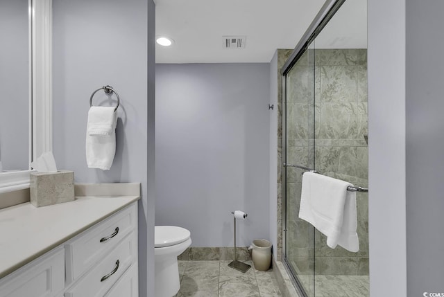 bathroom featuring a stall shower, visible vents, vanity, and toilet