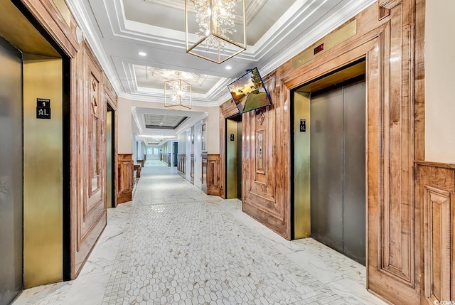 hall featuring a tray ceiling, elevator, crown molding, and a decorative wall