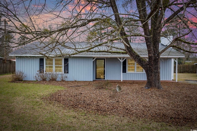 exterior space with fence and a front lawn