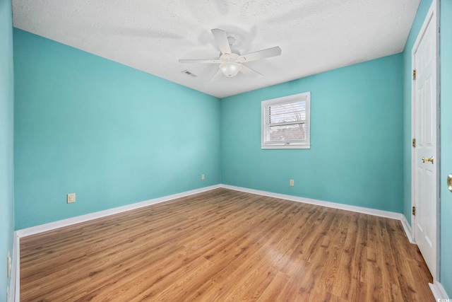 unfurnished bedroom featuring visible vents, a ceiling fan, a textured ceiling, light wood-type flooring, and baseboards