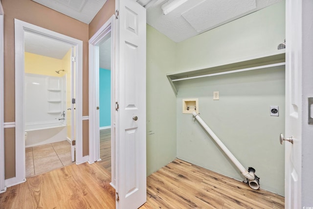 laundry area with laundry area, washer hookup, wood finished floors, and hookup for an electric dryer