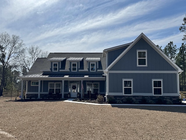 view of front of house featuring a standing seam roof, metal roof, a porch, and board and batten siding